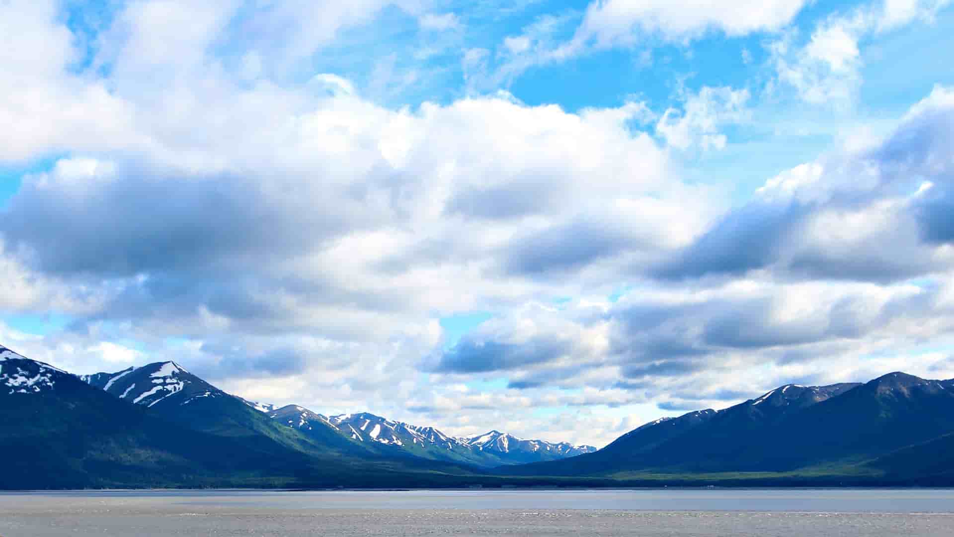 A vast body of water with mountains in the background, showcasing the beauty of Alaska.