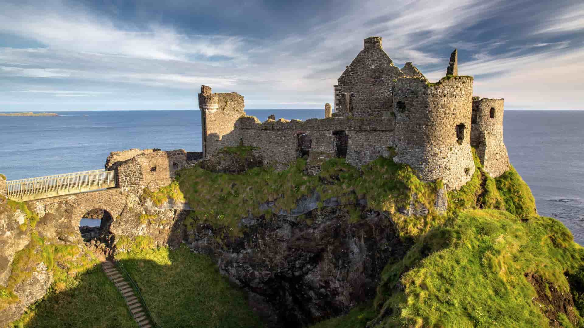 Dunluce Castle in Northern Ireland on a bright sunny day, an exciting visit during a Cosmos European tour.