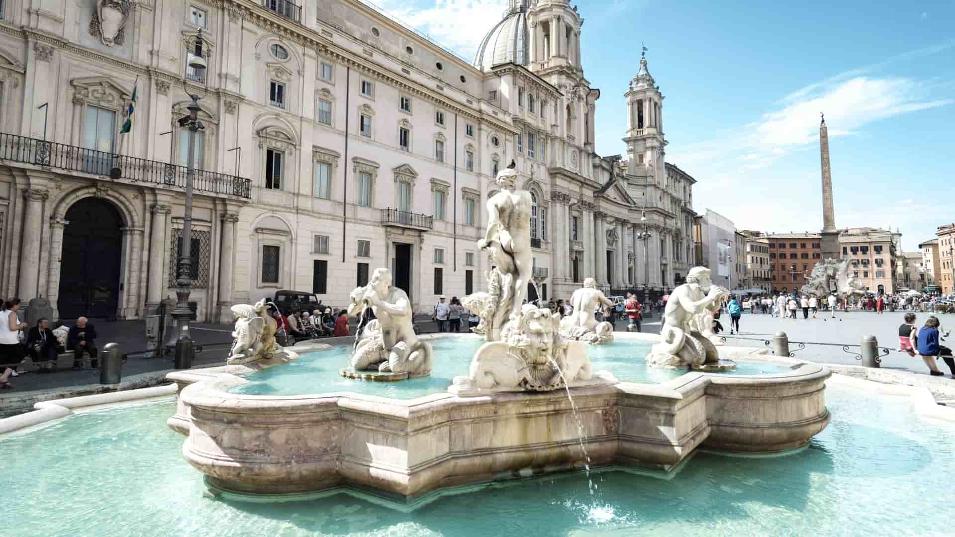 A gorgeous fountain filled with bright turquoise waters in the Piazza Navona located in Rome, Italy