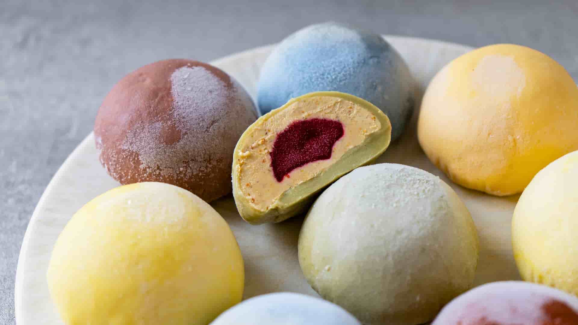 Close up of a colorful assortment of mochi, a traditional Japanese sticky rice dessert with ice cream added inside.
