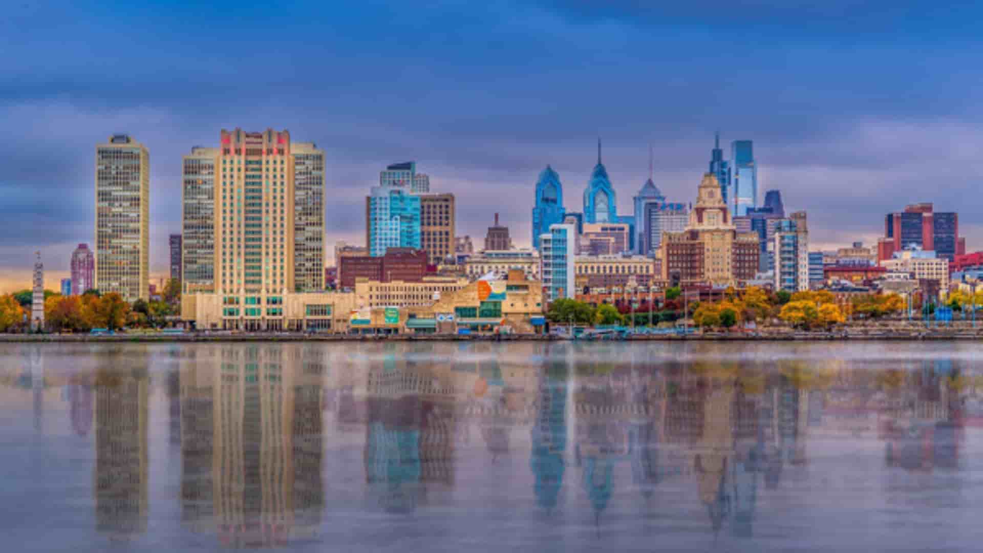 Vibrant Philadelphia cityscape reflection on Delaware River.