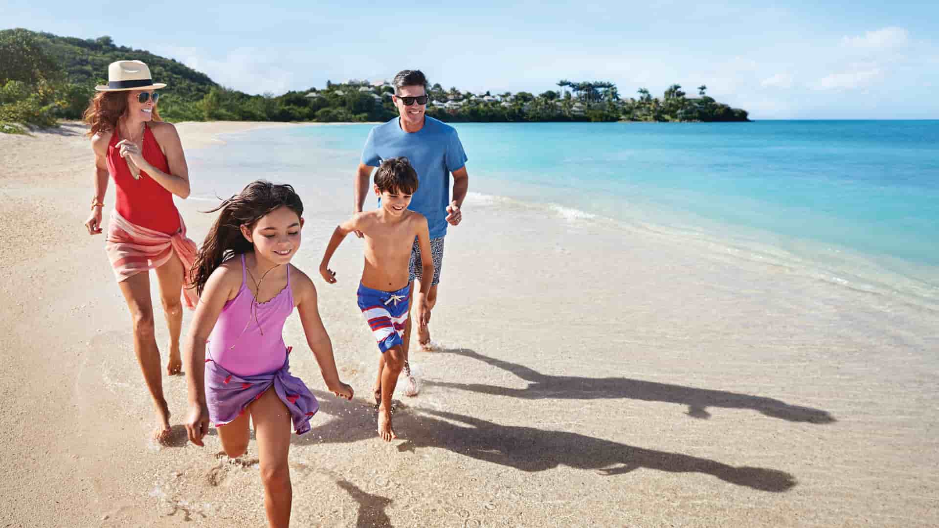 Family running along the beach during a shore excursion on a Princess Cruise to the Caribbean.