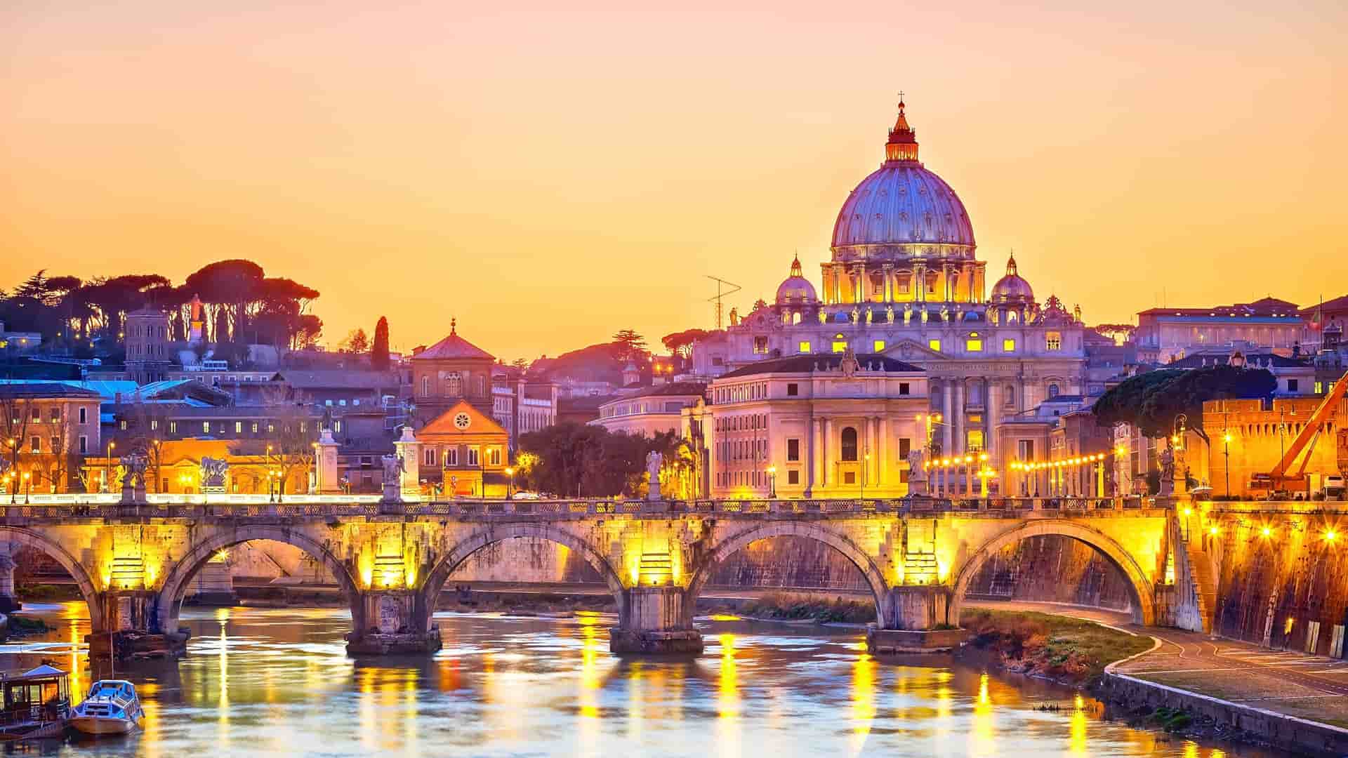 St. Peter's Basilica, Rome cityscape at sunset.