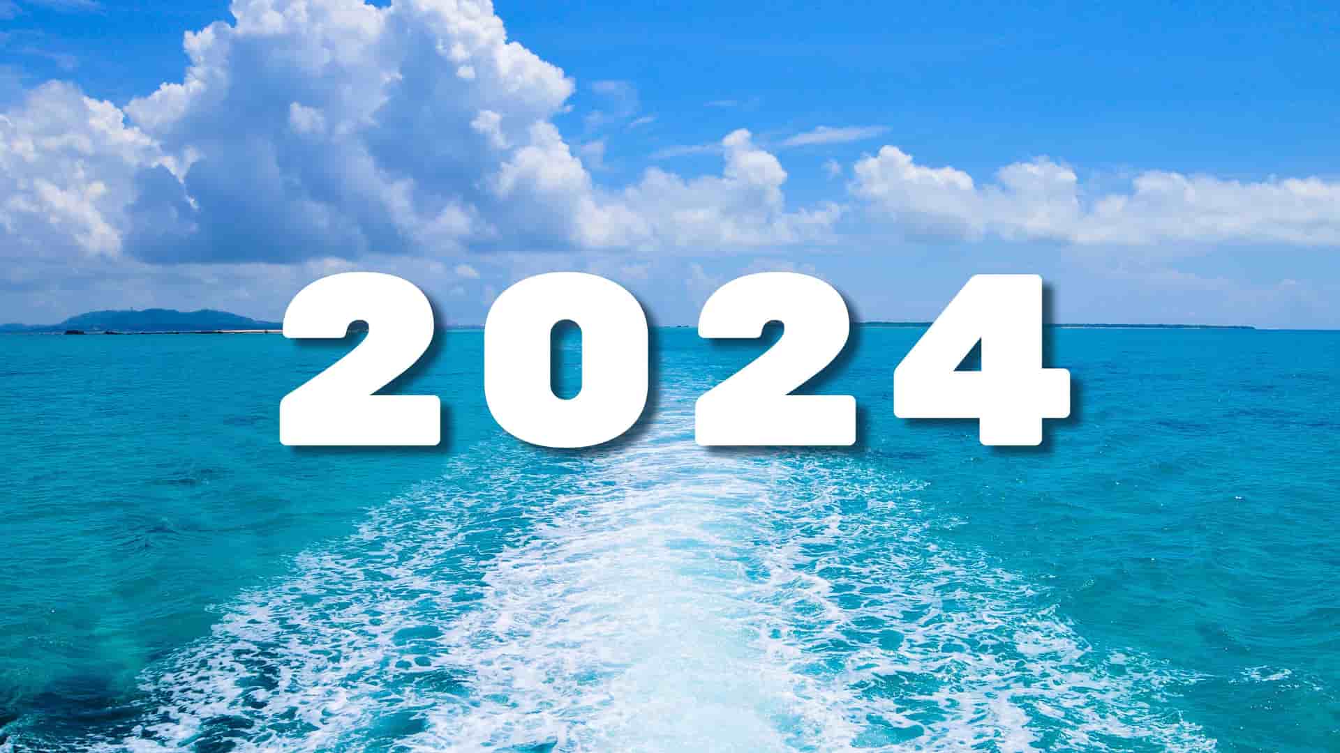 2024 written over the ocean waves on a bright sunny day.