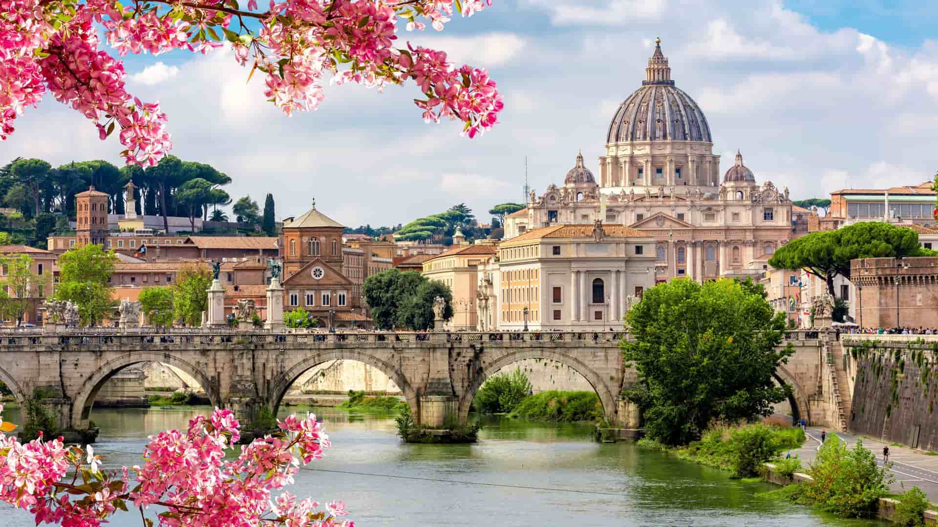 St Peter's Basilica in Vatican City and St. Angel bridge over Tiber River in spring, Rome, Italy
