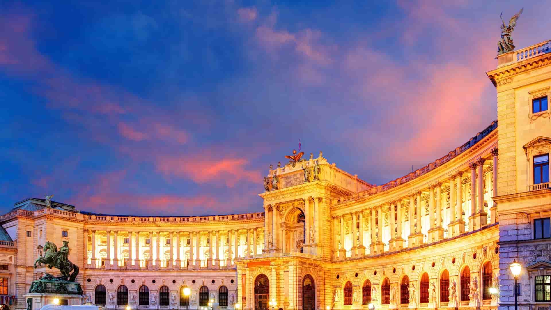 Hofburg Palace illuminated at dusk in Vienna, Austria.