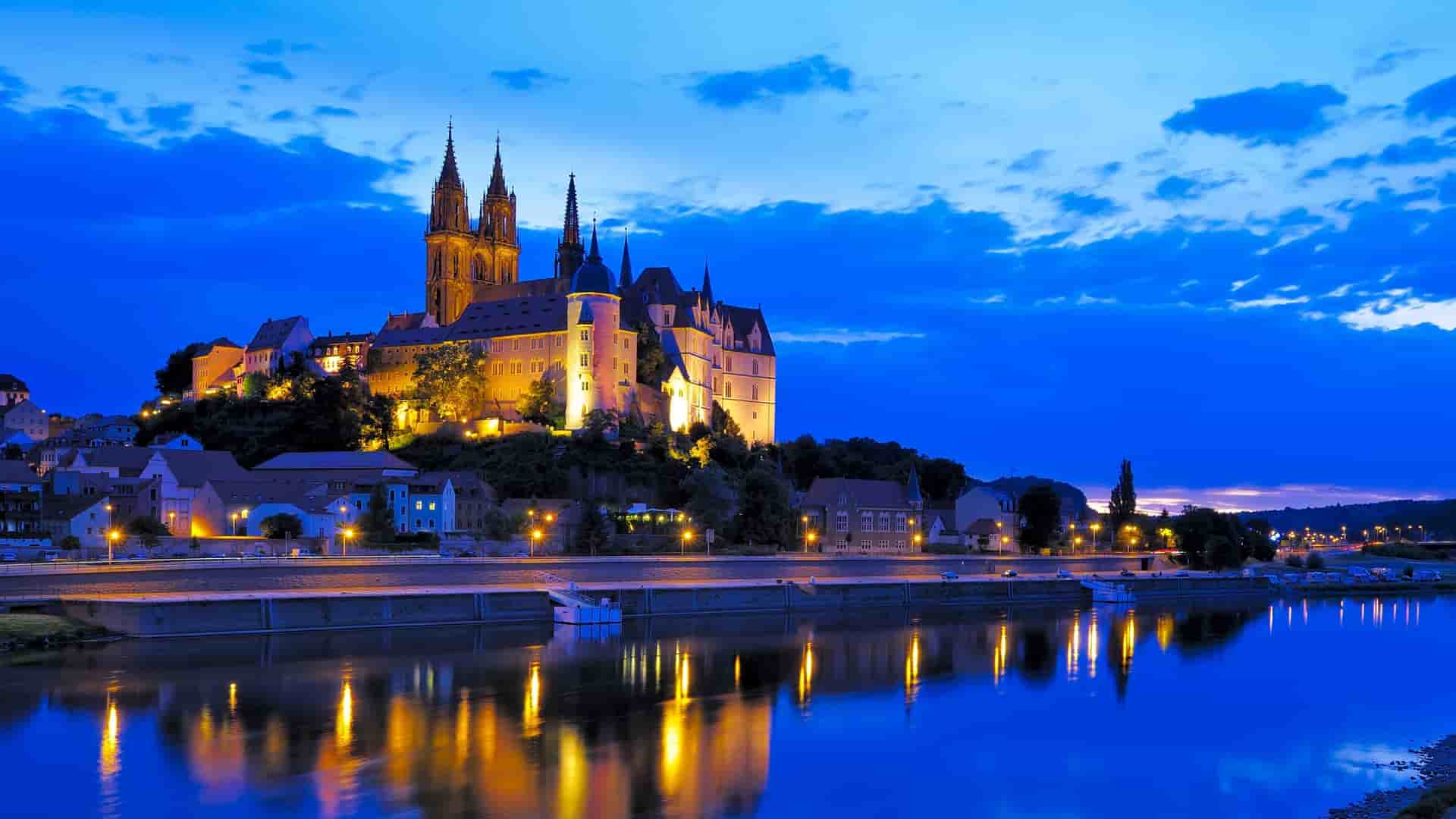 A Viking Longship sails along the Main River, passing the historic city of Würzburg and the Marienberg Fortress in Germany.
