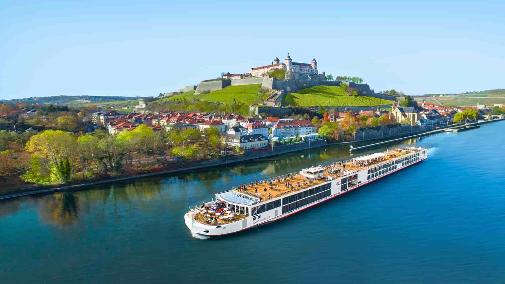 A Viking Longship sails along the Main River, passing the historic city of Würzburg and the Marienberg Fortress in Germany.