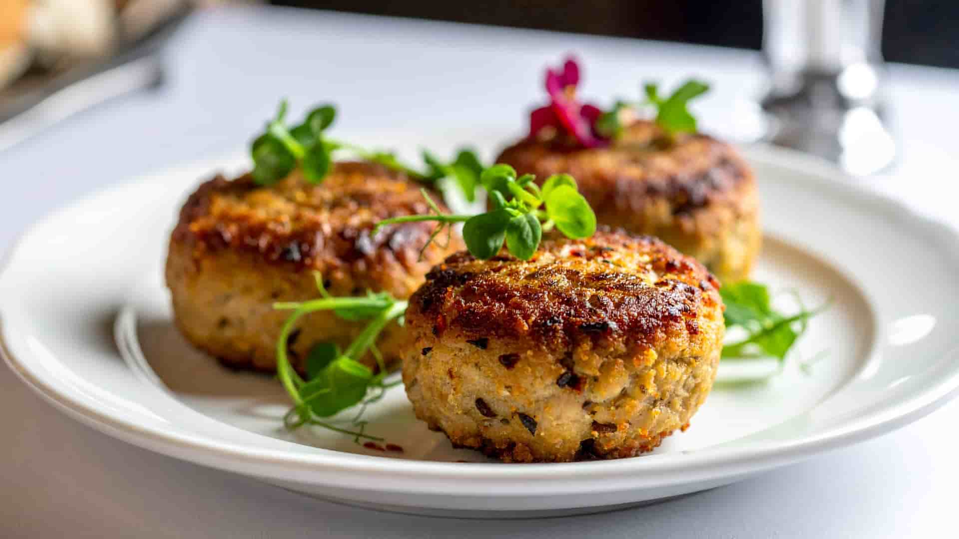 Three Alaskan crab cakes, an exciting dish made with local ingredients.
