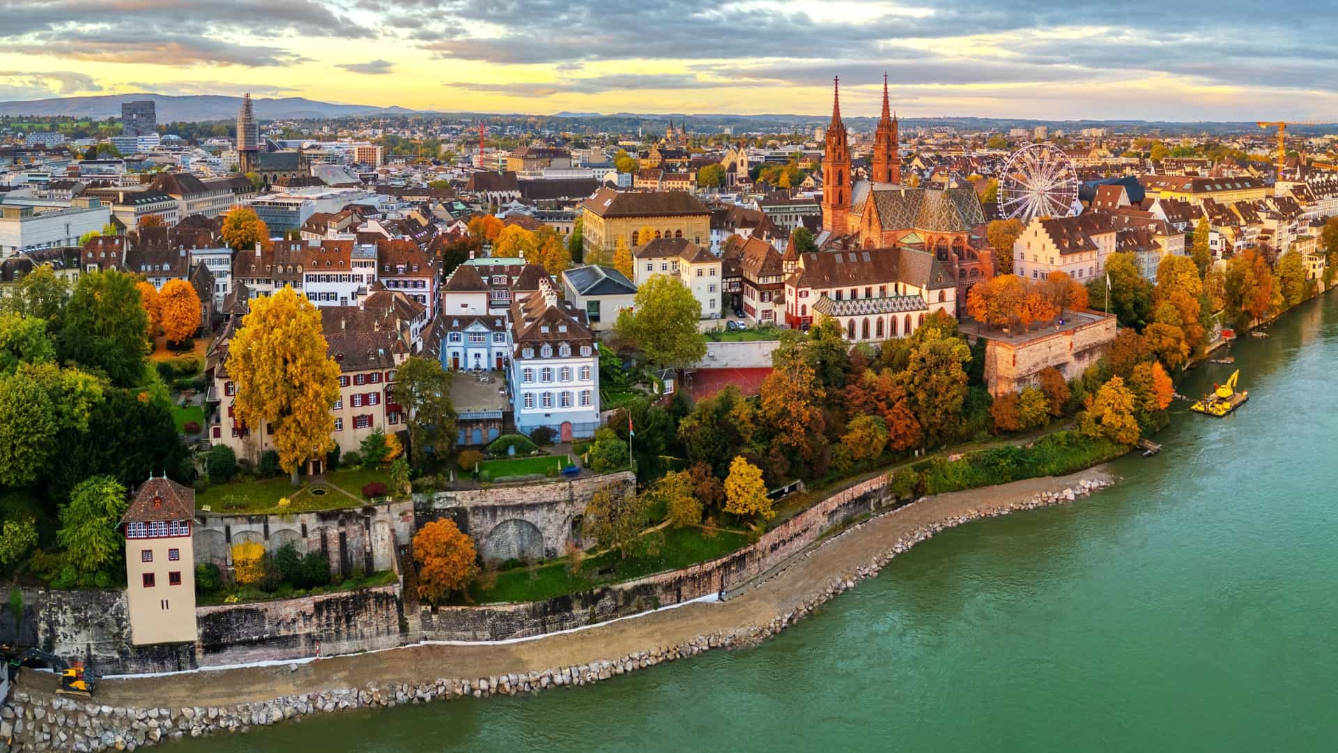 Aerial view of Basel, Switzerland, during autumn, showcasing the city's historic buildings and the serene Rhine River, a key destination on AmaWaterways river cruises.