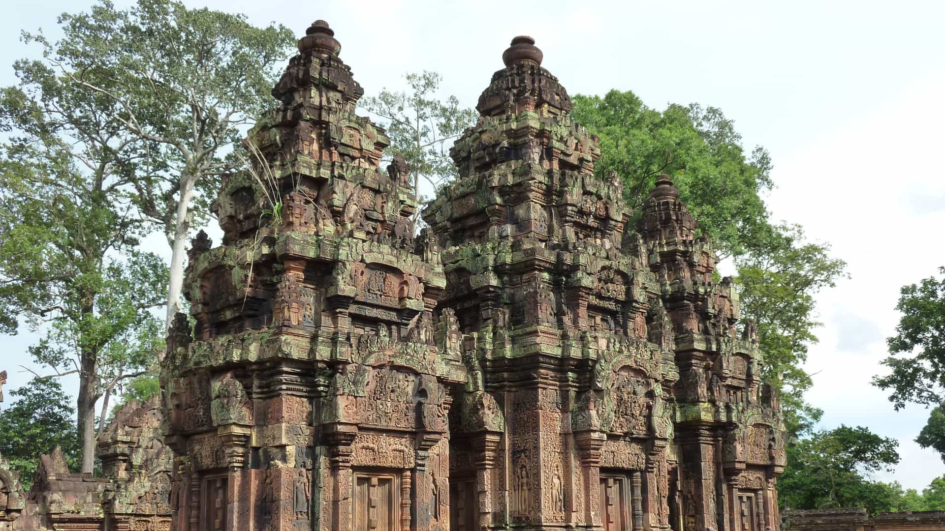 The intricate pink sandstone carvings of Banteay Srei temple in Cambodia, a historical and cultural highlight on an Avalon Waterways Asia itinerary.