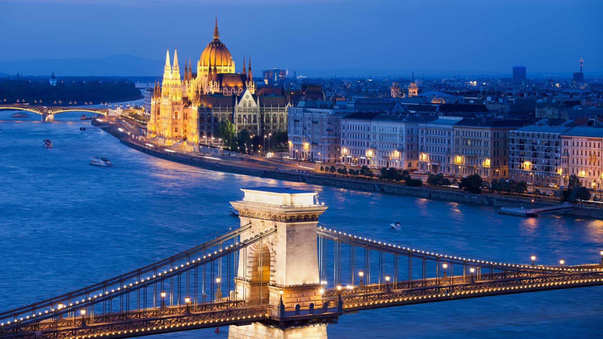 Budapest night view with illuminated Parliament, Chain Bridge, and Danube River. A highlight of Avalon Waterways cruises.