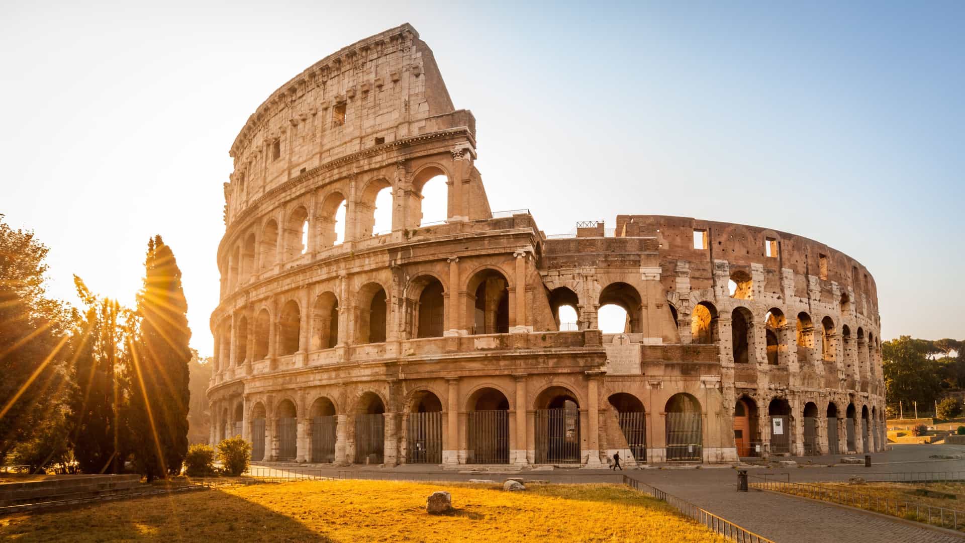 The Colosseum at sunrise in Rome, Europe, bathed in golden light, highlights ancient Roman history and is a featured stop for Avalon Waterways tours.