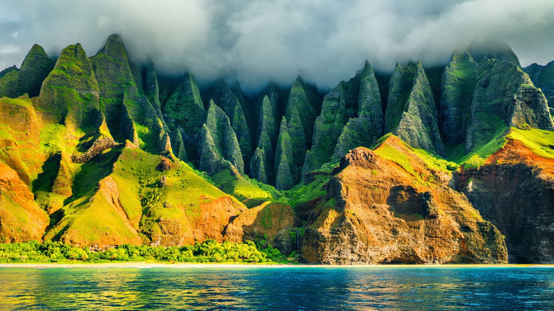 Azamara Cruises: Na Pali Coast, Kauai, Hawaii - dramatic emerald cliffs, valleys, beach, turquoise Pacific waters.
