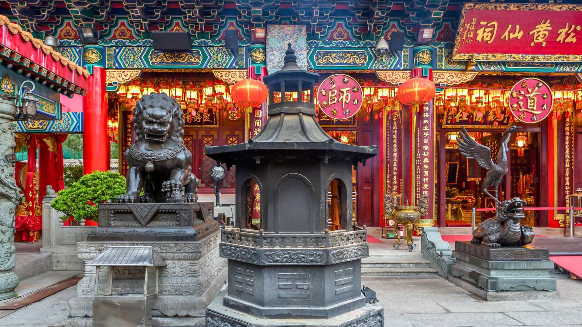 Traditional Chinese temple in Hong Kong with vibrant colors, lanterns, and statues on a Celebrity Cruises Asian itinerary.