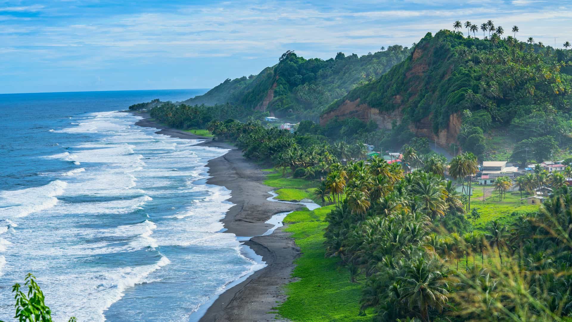 Aerial view of Black Point Beach in St. Vincent with black sand, waves, and green hills on a Celebrity Cruises Southern Caribbean itinerary.