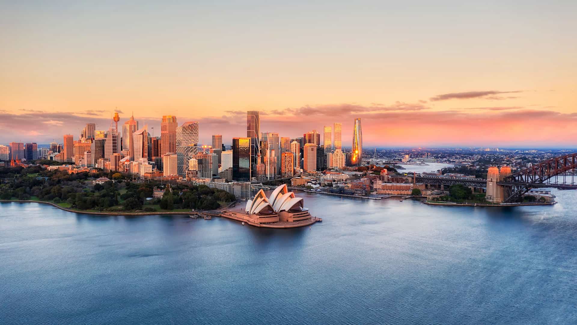Aerial view of Sydney cityscape, Opera House, and Harbour Bridge, showcasing Celebrity Cruises' Australian cruises.
