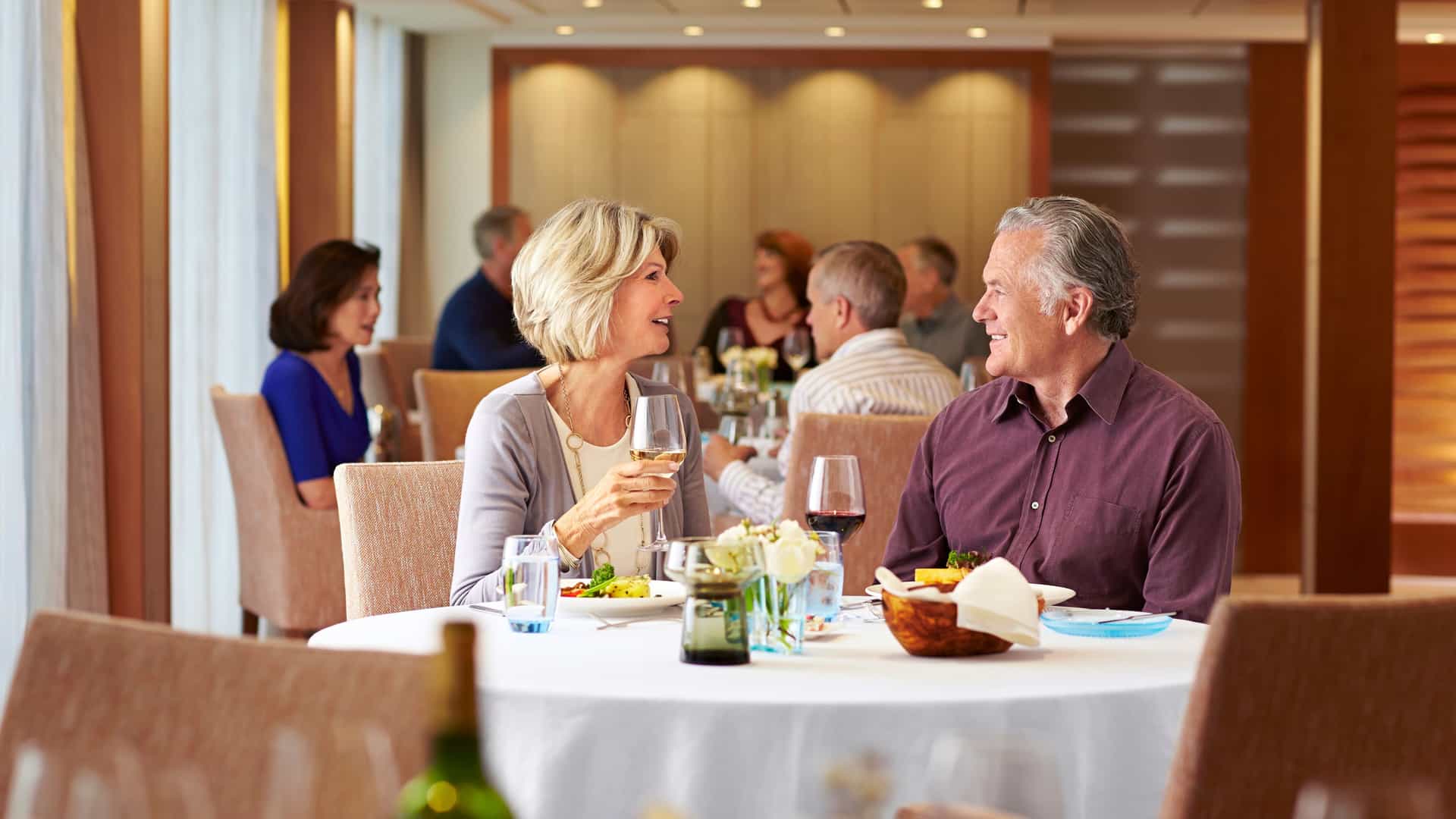Couple happily dining onboard a Viking River Cruise ship.