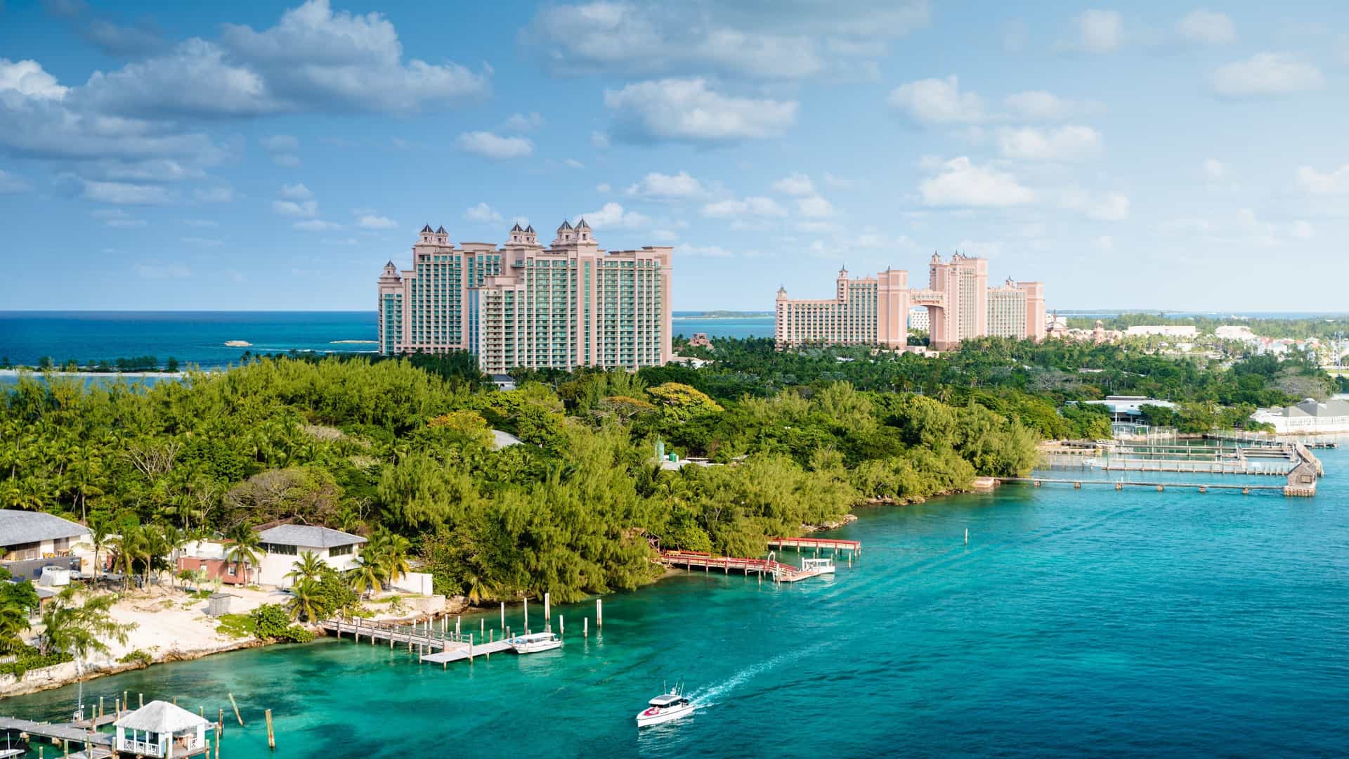 Turquoise waters and luxury resorts, representing the Cunard cruise experience in the Bahamas.