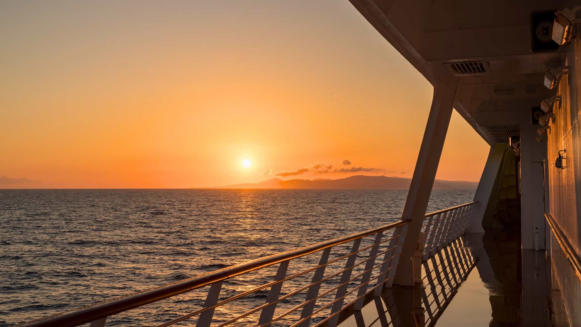 Cunard repositioning voyage highlighted by a stunning ocean sunset.