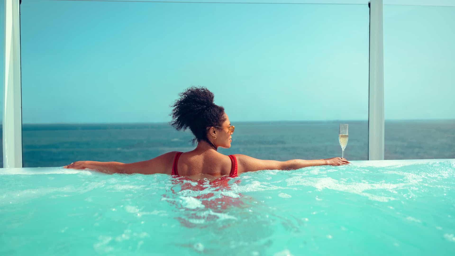 Indulge in luxury on the Cunard Queen Anne: hot tub, champagne, and ocean views await on a Transpacific cruise.