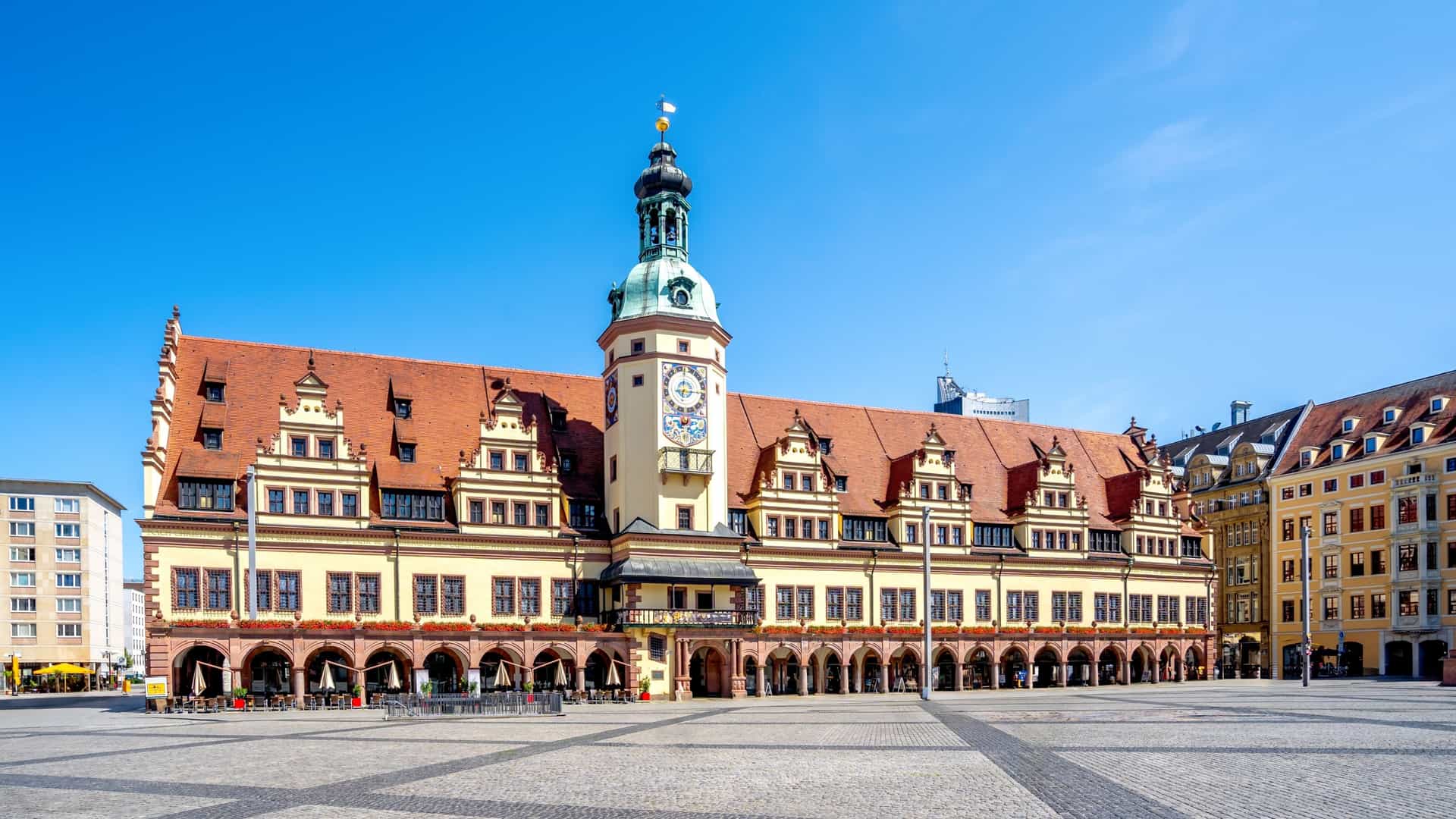The historic, long Old City Hall, a prominent German Renaissance building, stands on the bustling Market Square in Leipzig, Saxony.