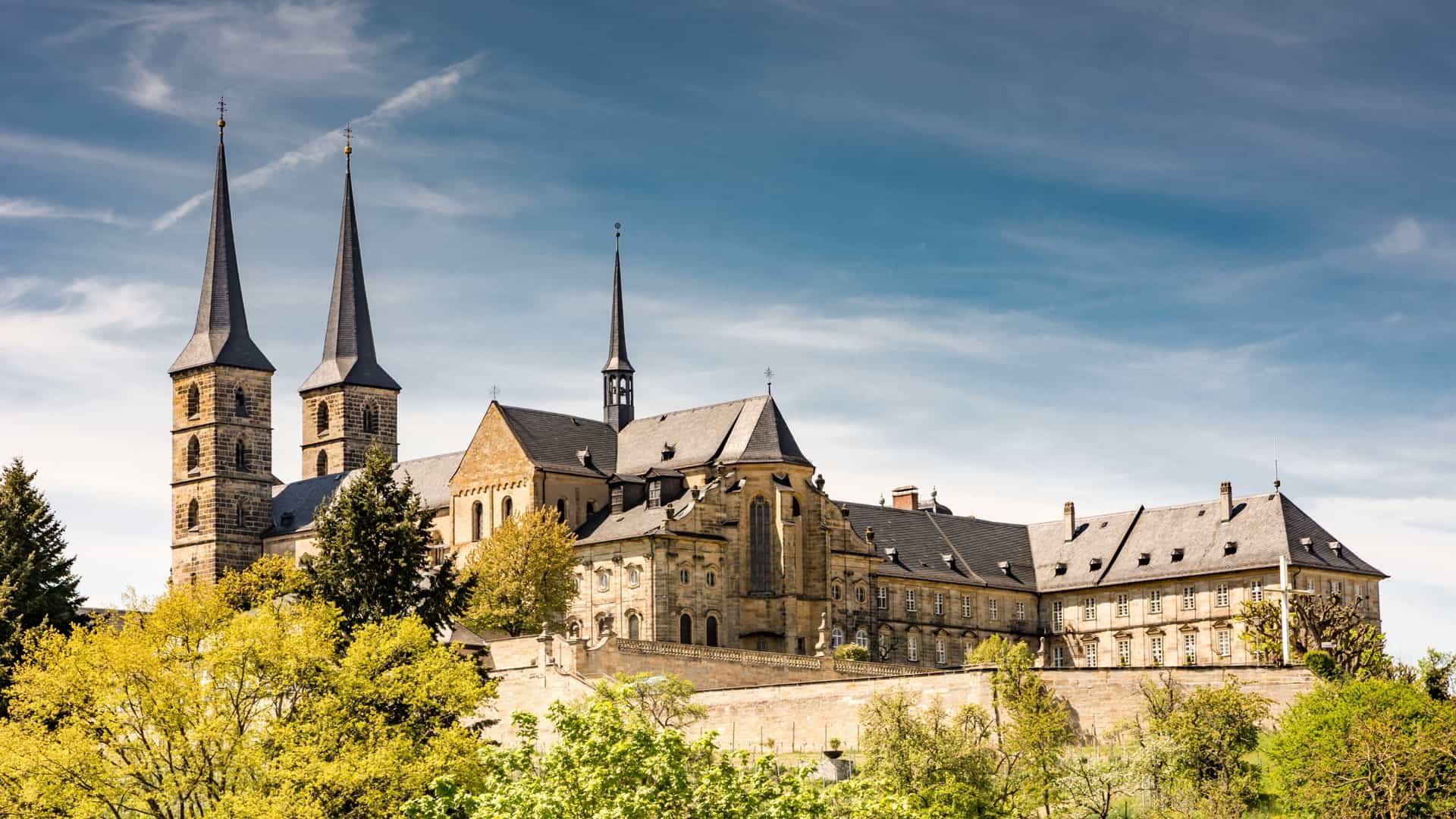 The historic Michelsberg Abbey (Kloster Michelsberg), a former Benedictine monastery, sits atop the Michaelsberg hill, dominating the Bamberg cityscape with its impressive Baroque architecture.