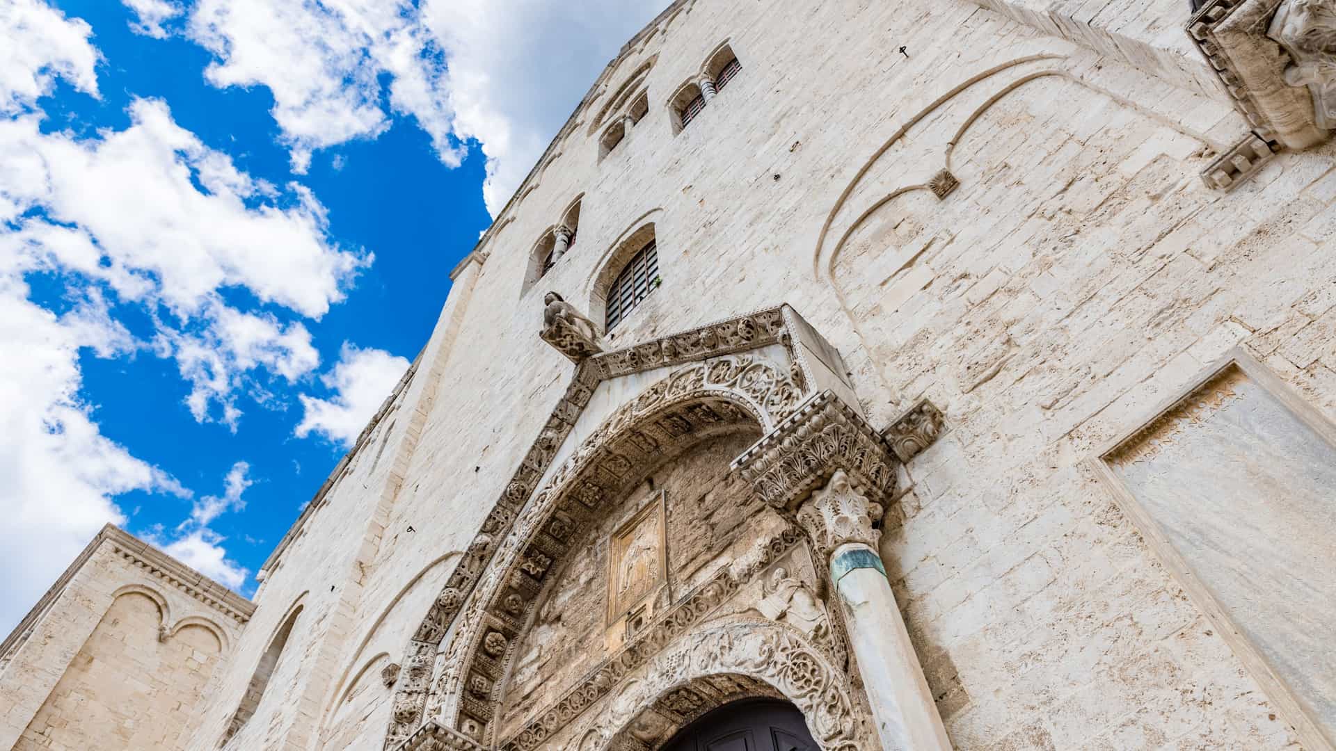 The exterior of the Basilica di San Nicola in Bari, Italy, a significant example of Apulian Romanesque architecture.