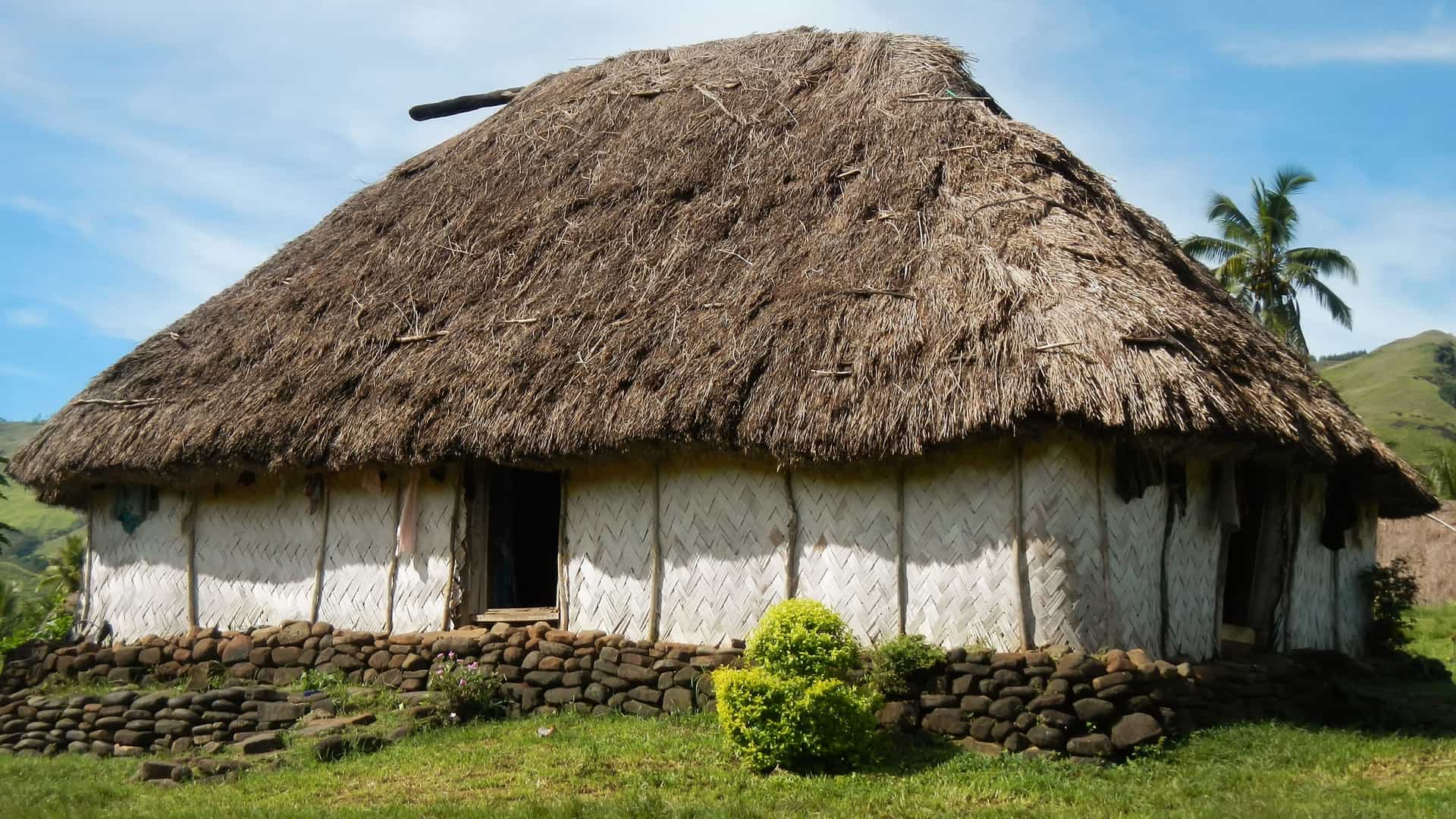 A view of a traditional Fijian house, or bure, with a distinctive high, thick thatched roof, in Navala Village, located in the highlands of Viti Levu, Fiji. Navala is one of the few remaining settlements in Fiji that maintains its completely traditional architecture.