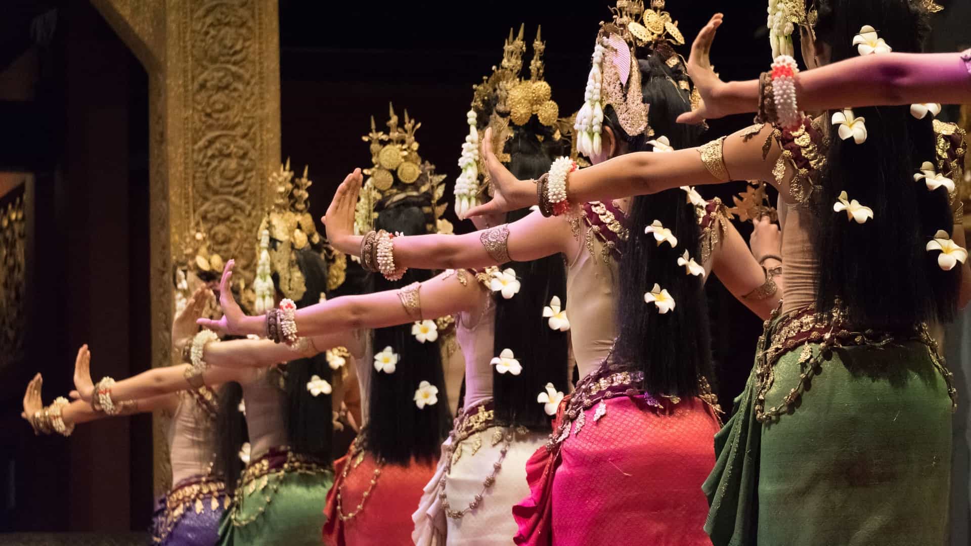  A close up of the beautiful hands of an Apsara Khmer dancer, posed in a traditional, intricate mudra (hand gesture) while performing a dance depicting the Ramayana epic in Siem Reap, Cambodia. The dancer is wearing elaborate, colorful traditional costume jewelry.