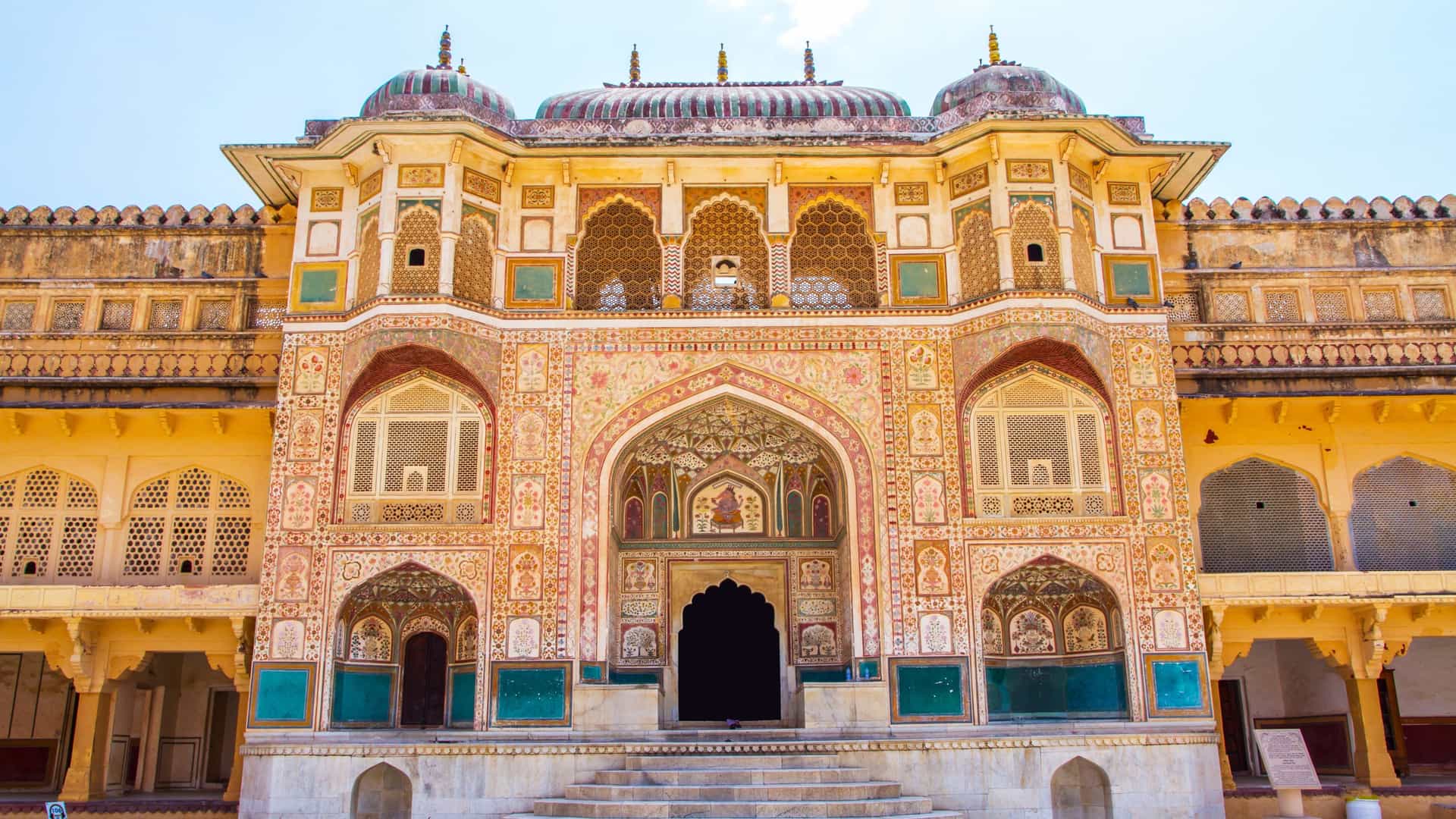 Explora journey view of the ornate architecture and intricate carvings at Amber Fort in Jaipur, India.