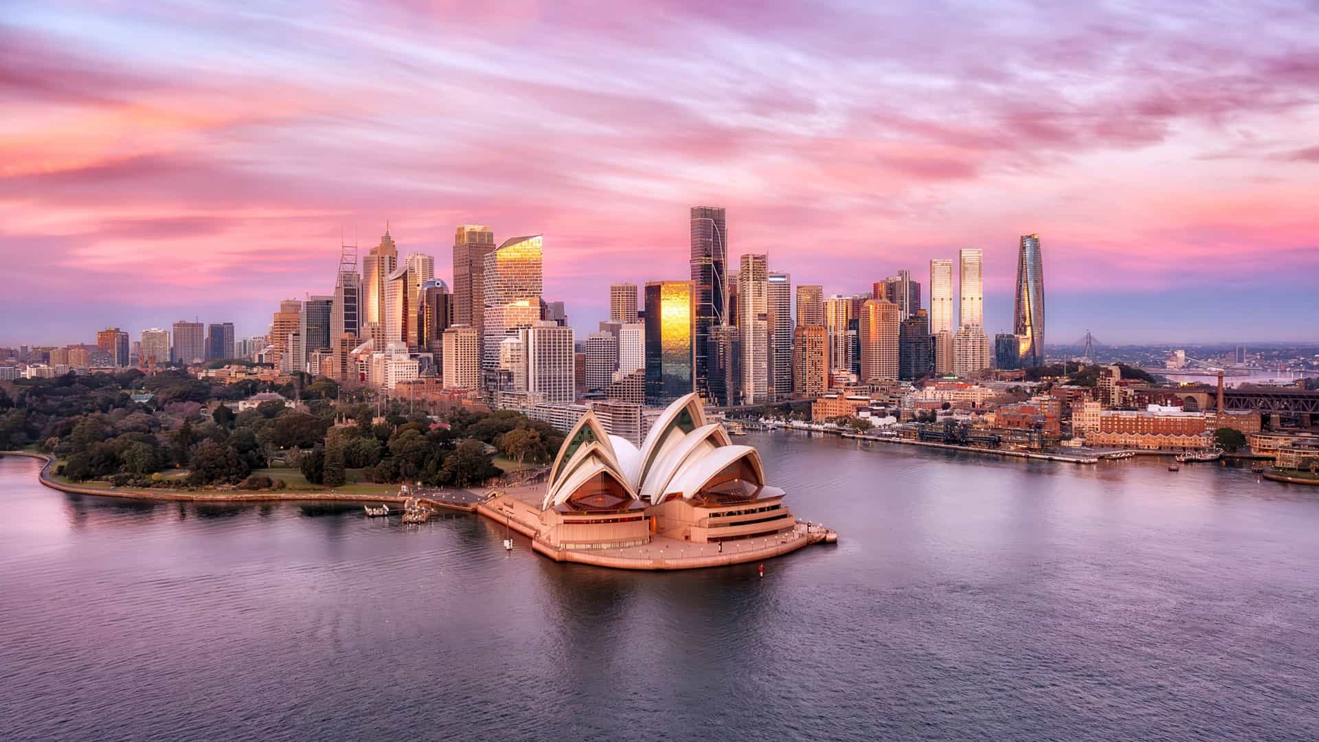 Explora journey view of the Sydney Opera House and city skyline at sunset in Australia.