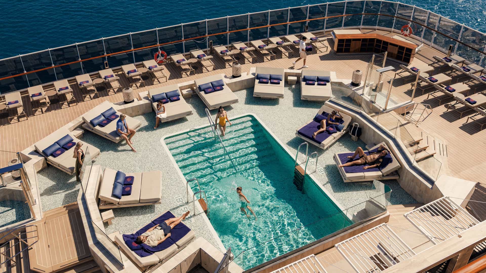 A family enjoying the Astern Pool on an Explora Journeys cruise,
