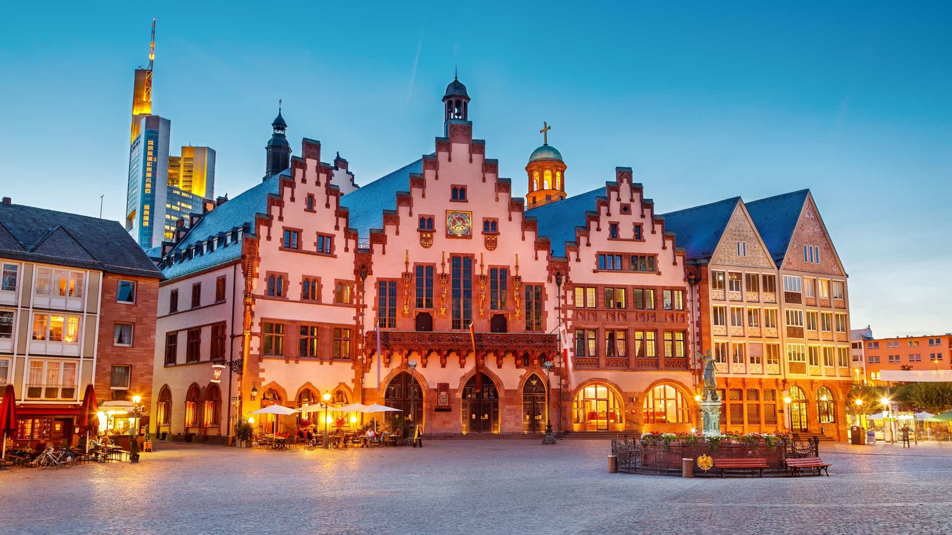 Frankfurt skyline reflected in river at dusk.
