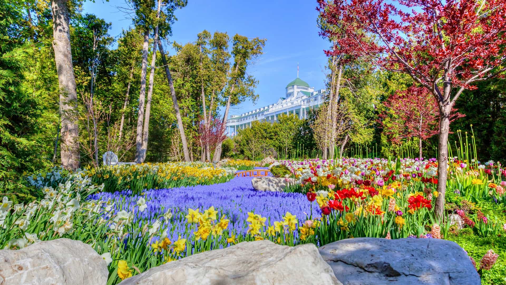 Large colorful flowerbed in front of The Grand Hotel.