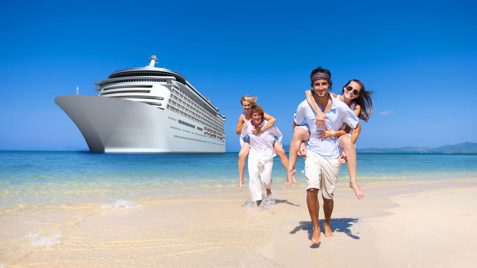 A group of four plays on the beach, while a cruise ship floats in the distance behind them.