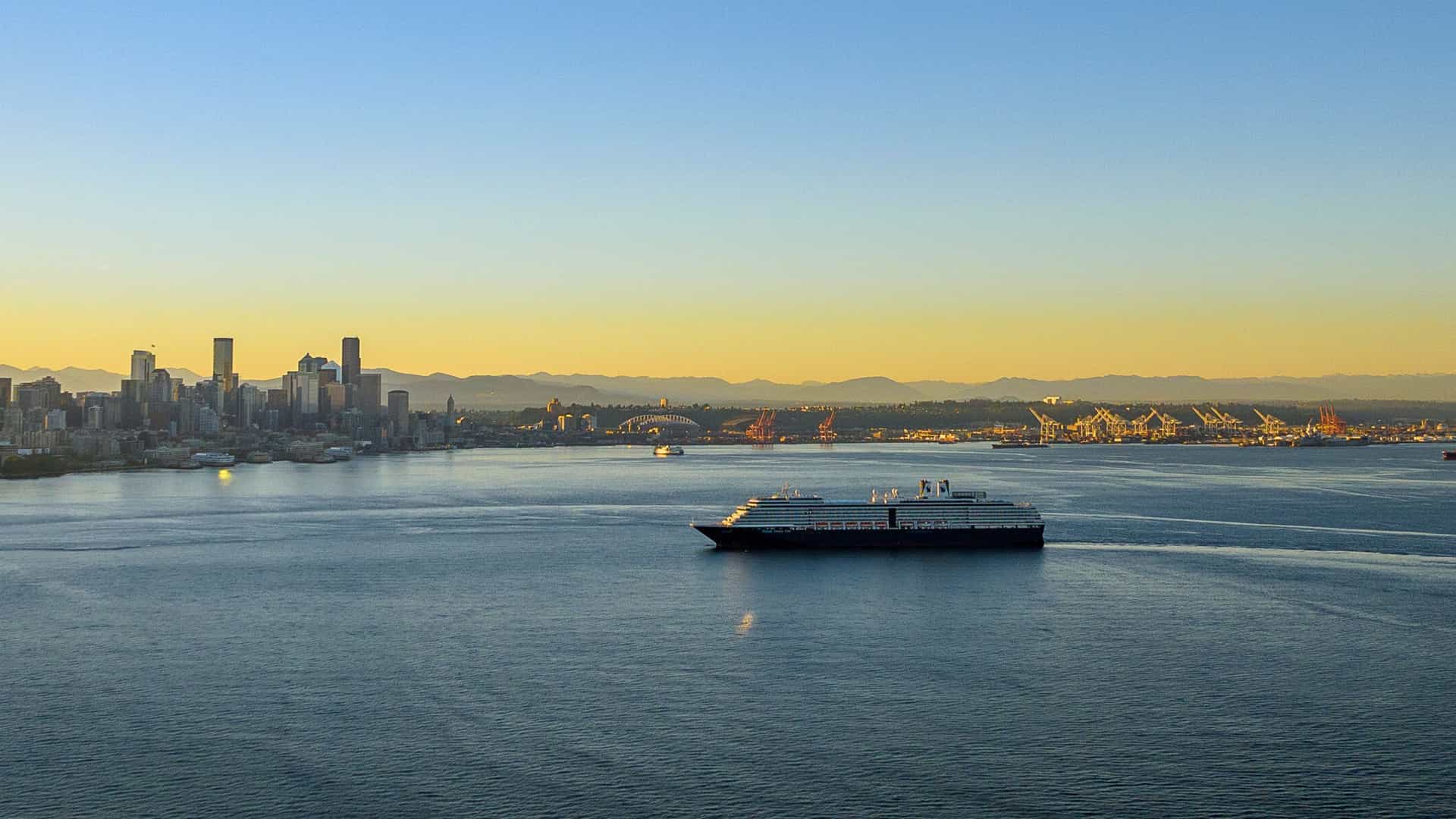 Holland America Westerdam begins a Trans-Pacific cruise from Seattle, with Mount Rainier in the background.