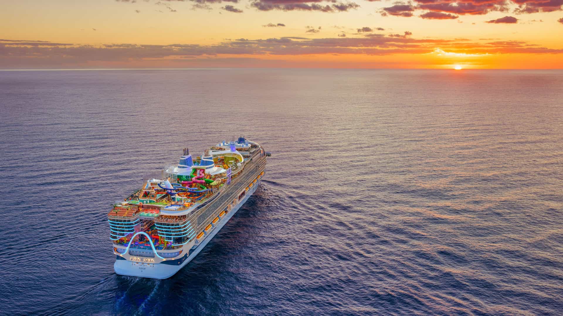 Aerial view of Icon of the Seas sailing at sunset.