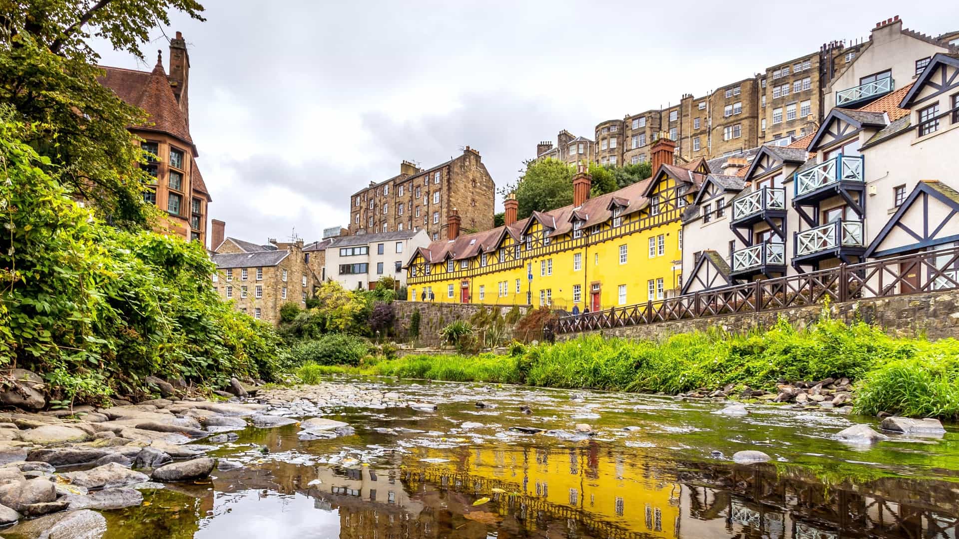 Dean Village with colorful buildings and a river in Edinburgh, Scotland.