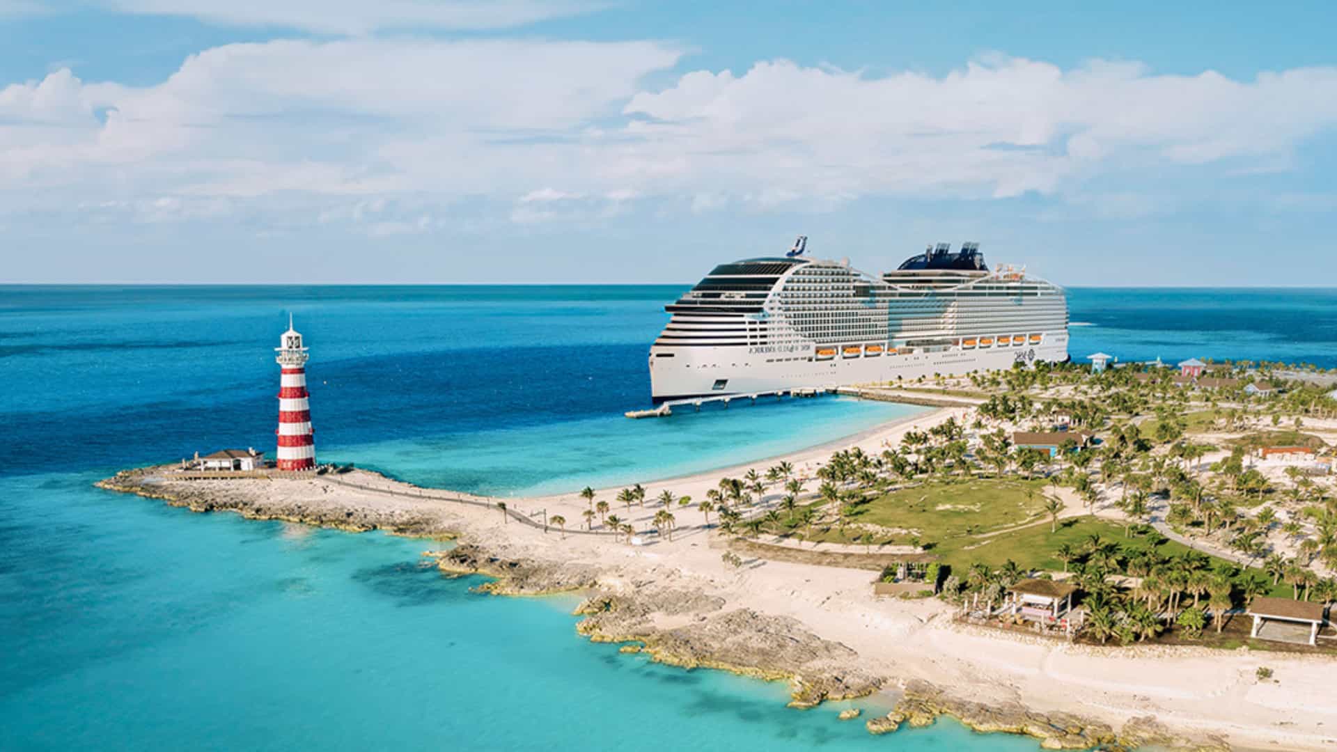 MSC cruise ship docked on the shore of MSC's private island in the Bahamas, MSC Marine Reserve, surrounded by bright blue and turquoise waters.