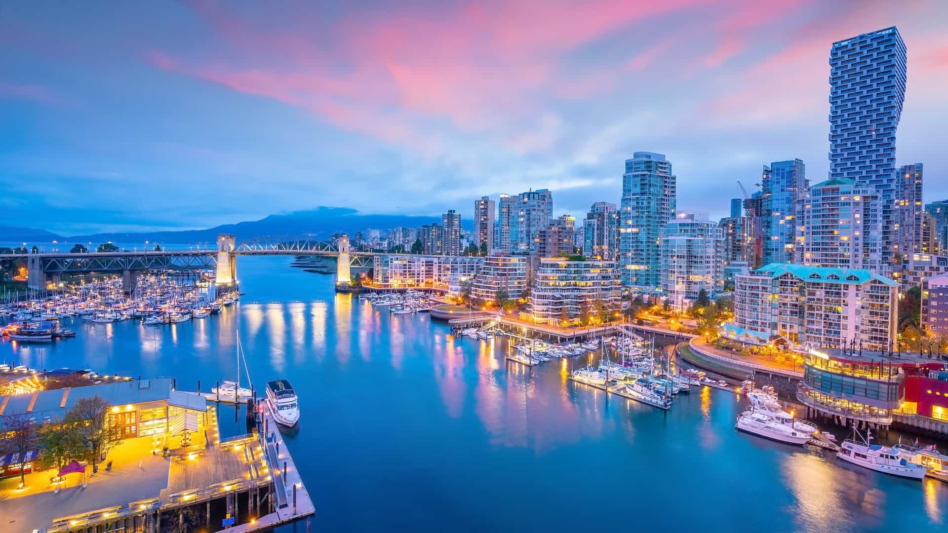 Norwegian Cruise Line: Vibrant sunset over Vancouver, British Columbia, Canada – a major gateway port for US Pacific Coast cruises. The image features a bustling harbor, modern city skyline, and prominent bridge.