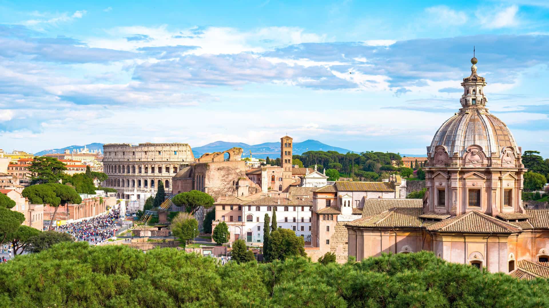 A scenic panoramic view in Europe, featuring the ancient Colosseum and historic cityscape of Rome, Italy, a popular port for Oceania cruises.