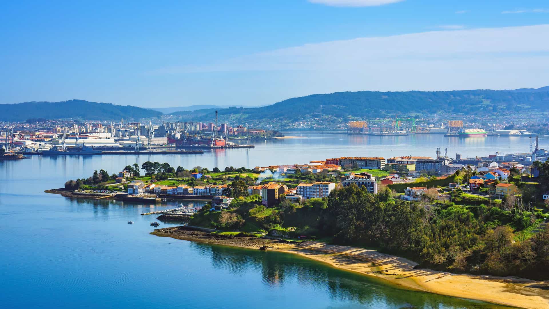 A panoramic view of El Ferrol, Spain, showcasing a vibrant coastal town and a busy industrial port with cranes and ships, surrounded by lush green hills and a clear blue bay.