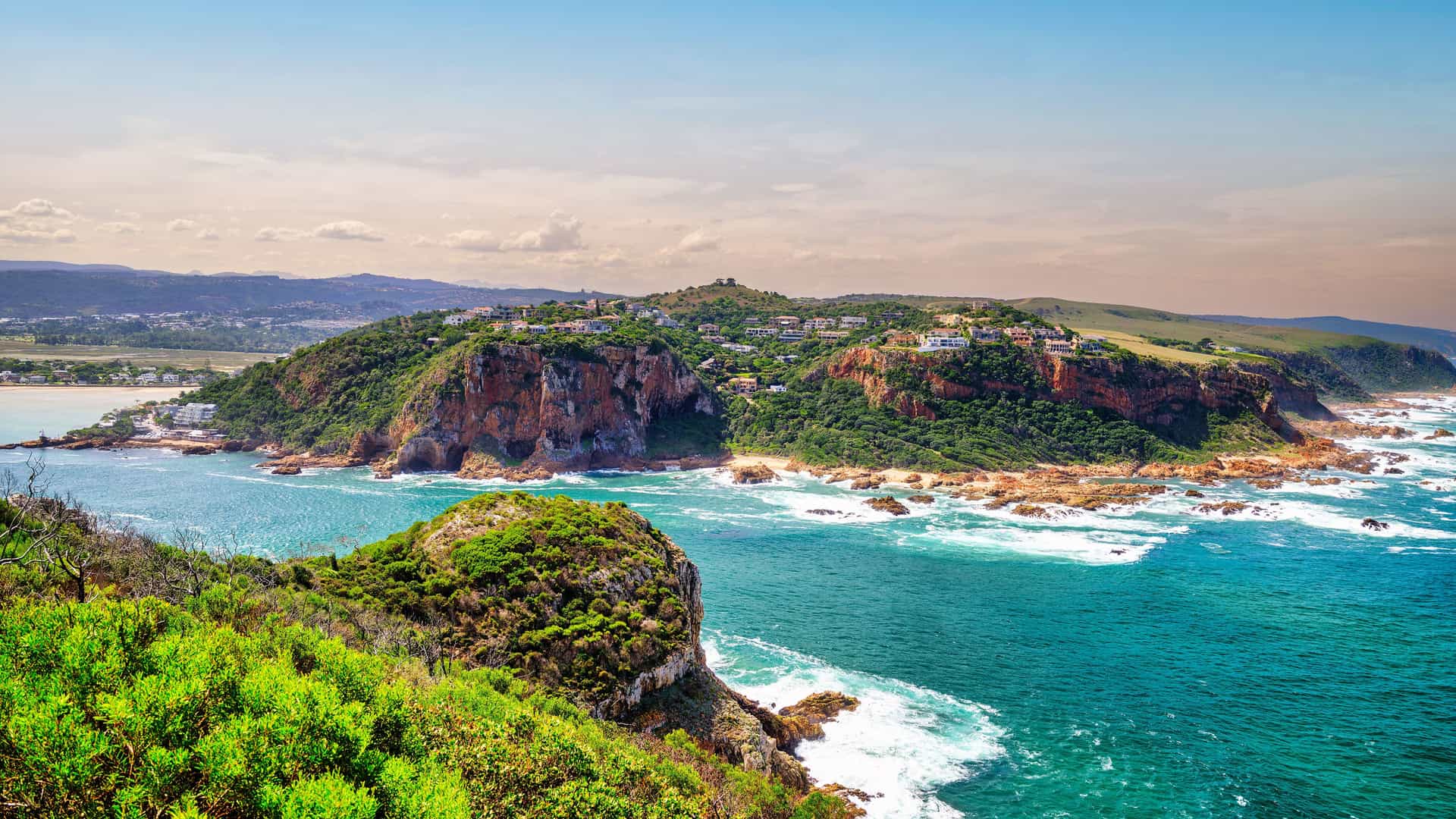 "A scenic view of the Knysna Heads, two dramatic sandstone cliffs marking the entrance to the Knysna Lagoon from the Indian Ocean on the Garden Route of South Africa.  "