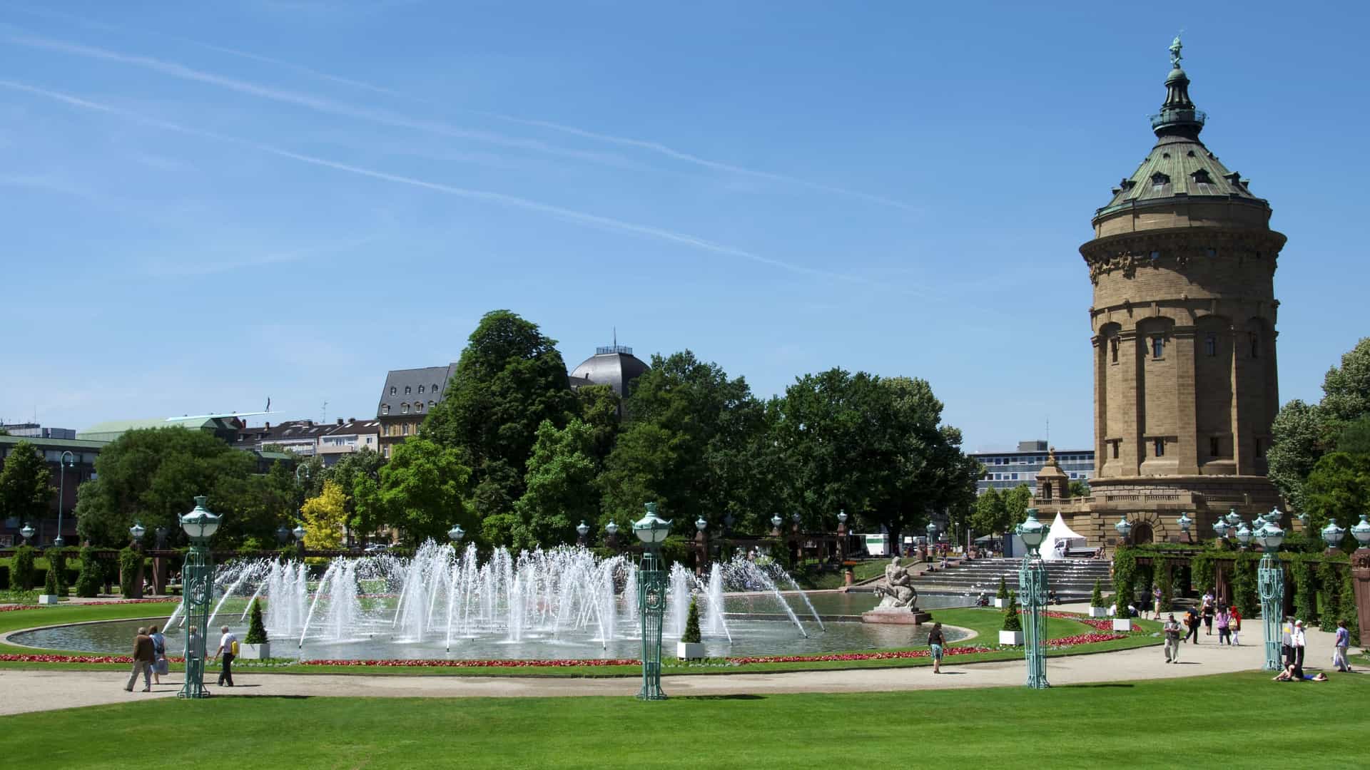 A scenic view of the Mannheim Water Tower and the Art Nouveau-style fountain in Friedrichsplatz, a beautiful public park and popular landmark in Mannheim, Germany.