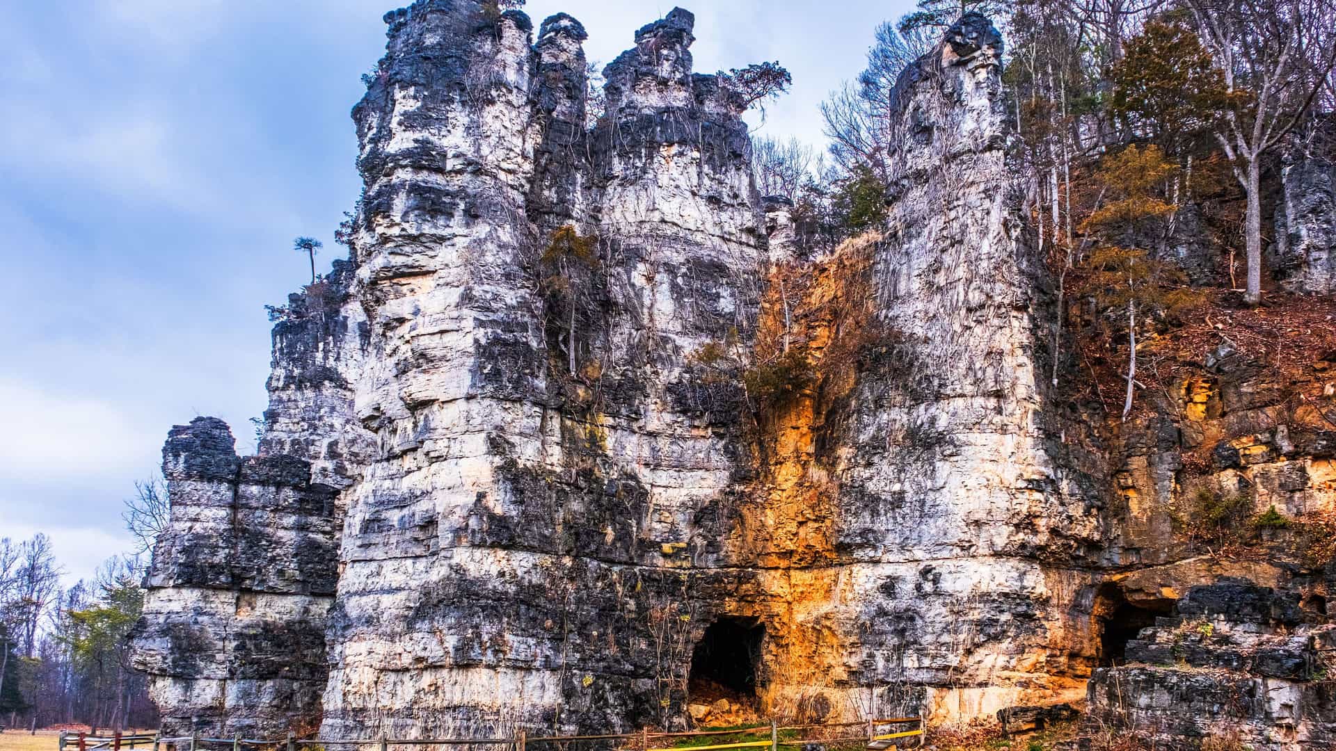 "A striking view of the towering limestone rock formations at Natural Chimneys Park in the Shenandoah Valley, Virginia, with a walking path at its base.  "