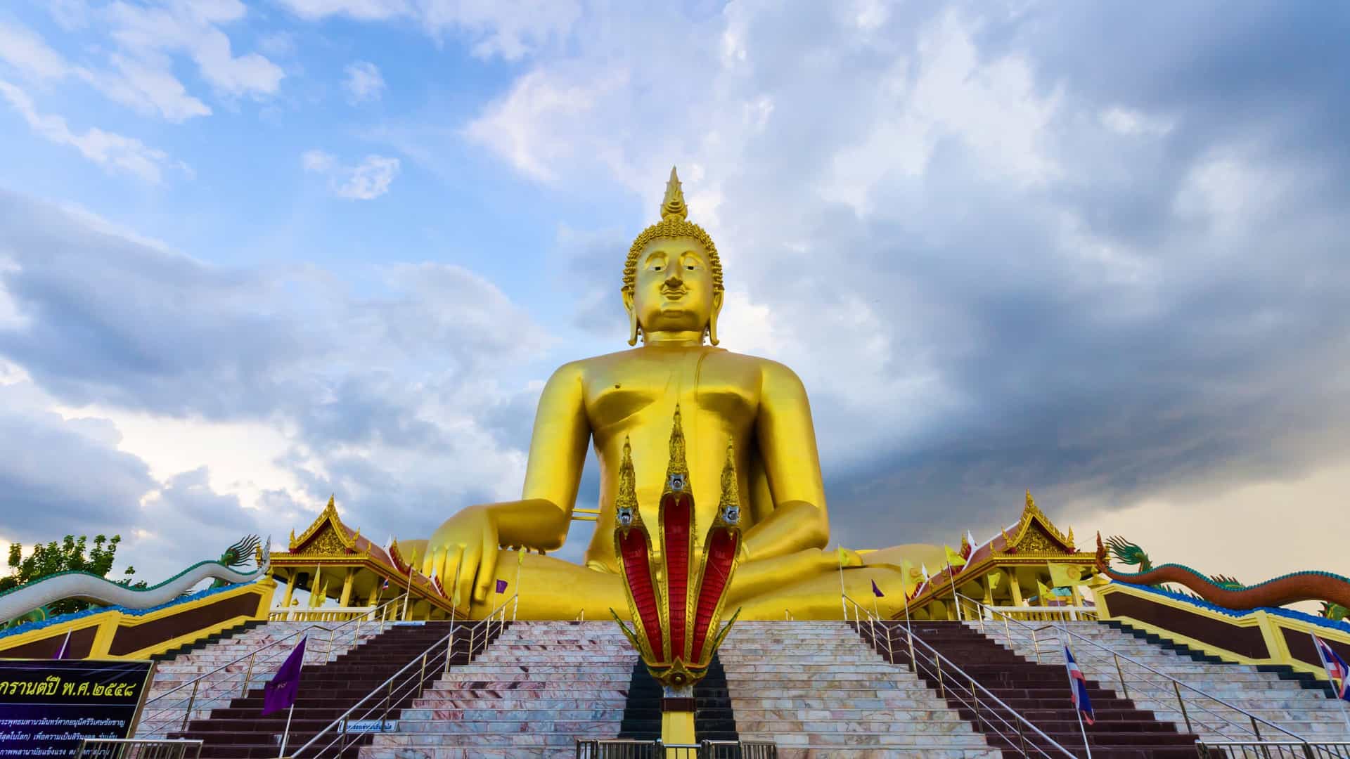 A magnificent golden Buddha statue at a Thai temple, representing the rich cultural experiences available on Princess Cruises to Asia.