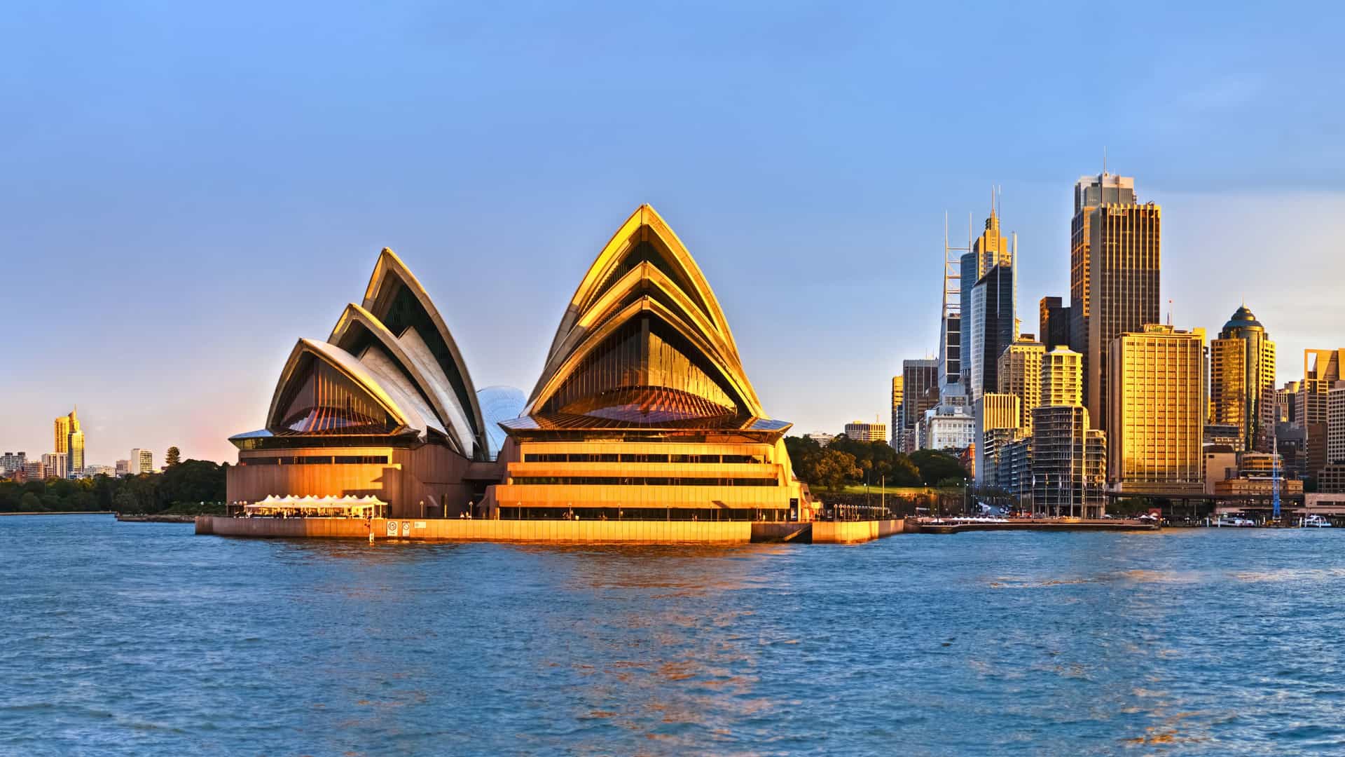 Panoramic view of the iconic Sydney Opera House and city skyline at sunset, a stunning destination on Princess Cruises' Australia itineraries.