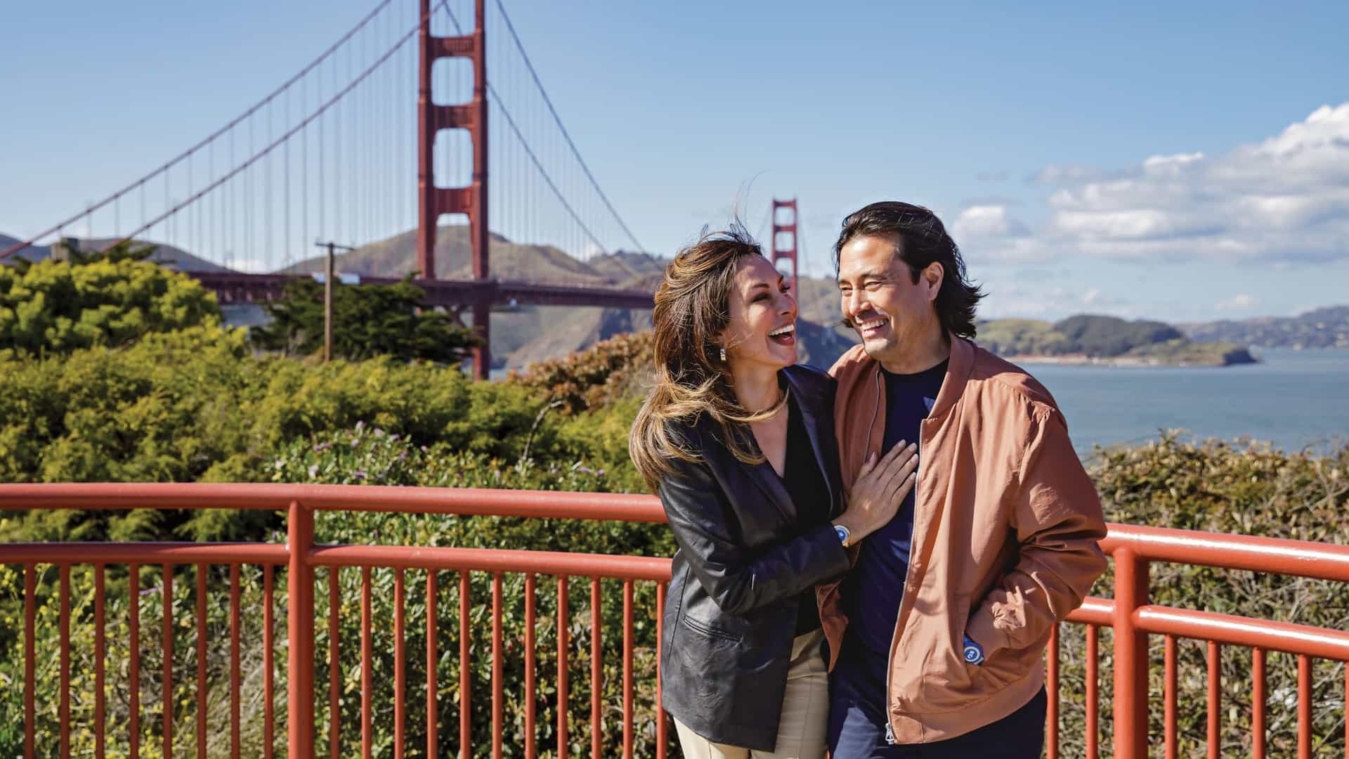 A cheerful couple enjoys the view of the Golden Gate Bridge in San Francisco, a highlight of a Princess Cruises Pacific Coast itinerary.