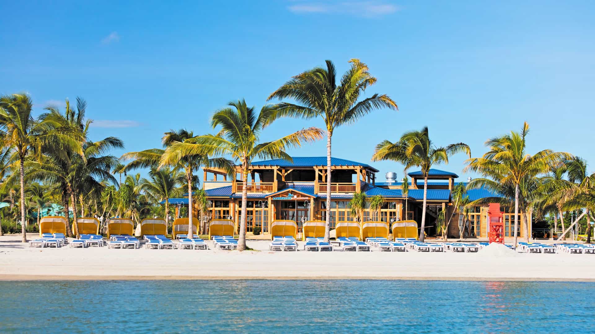 Regent Seven Seas Caribbean cruise experience at the exclusive Harvest Caye in Belize, featuring a beautiful beach and resort amenities.